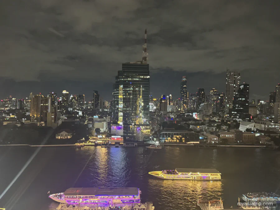 Illuminated boats on the Chao Phraya River at night