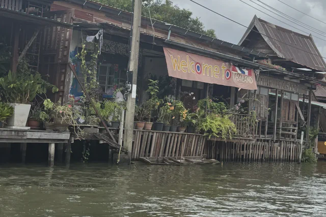 Wooden riverside homes seen from a boat on the Chao Phraya River