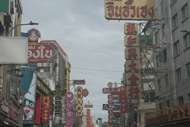 Neon signs and evening traffic along Yaowarat Road in Bangkok Chinatown