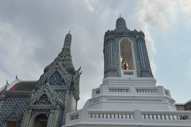 Guardian statues and temple roofs inside Bangkok's Grand Palace