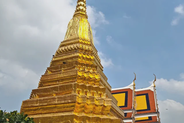 Golden chedi with guardian figures inside Bangkok's Grand Palace