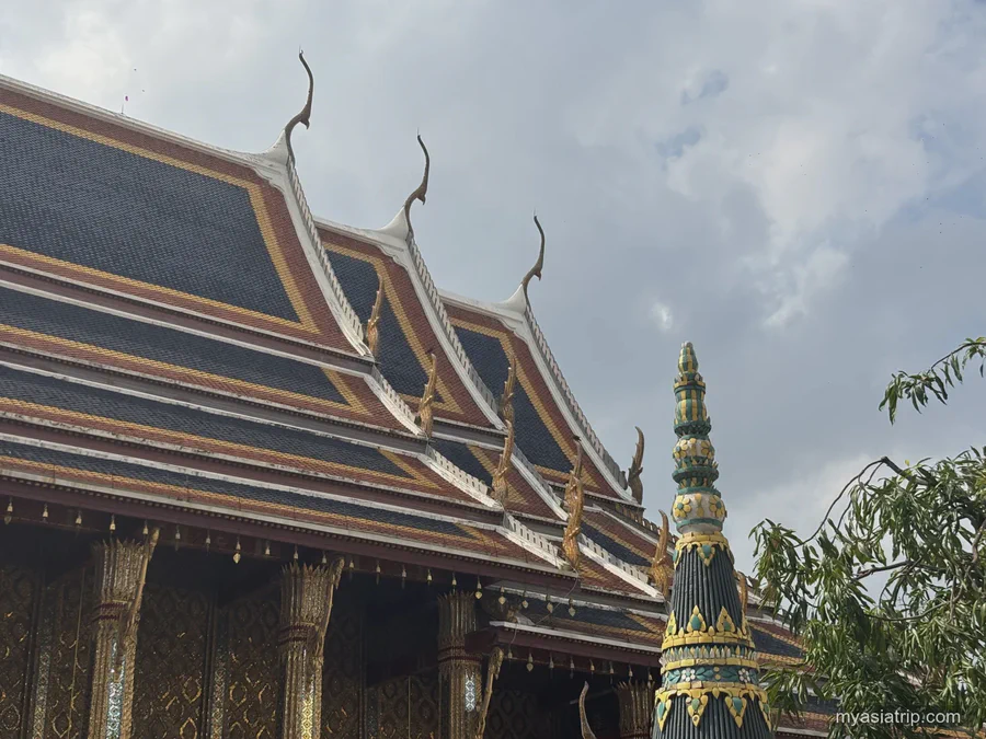 Layered rooflines and ornate gables inside Bangkok's Grand Palace