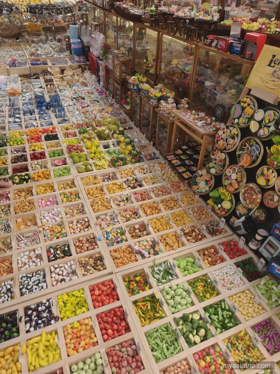 Rows of colorful Thai craft items at a Bangkok market