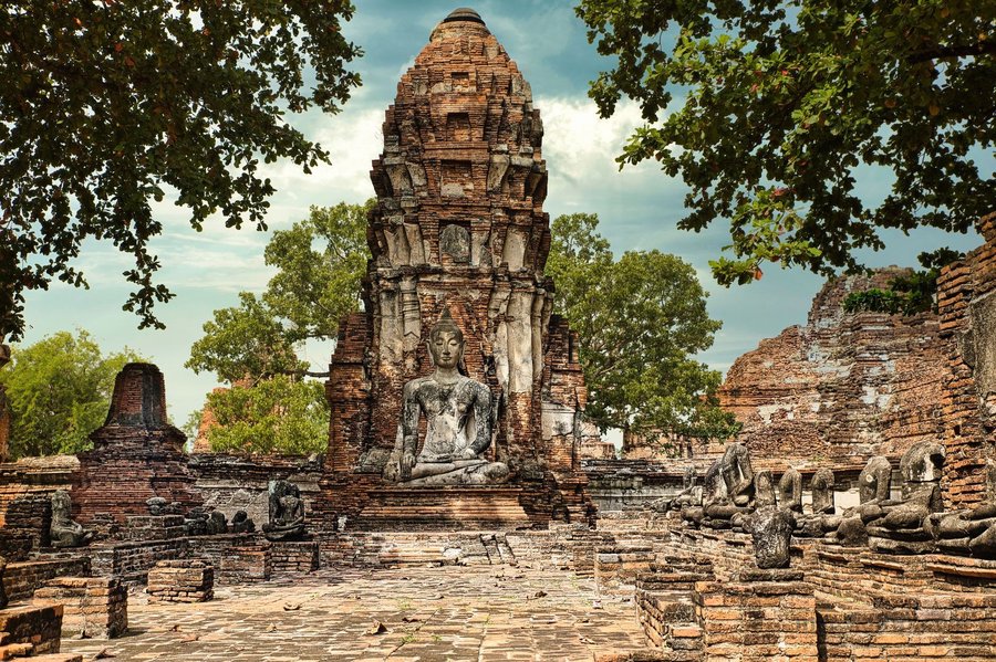 Buddha statue framed by historic ruins in Ayutthaya