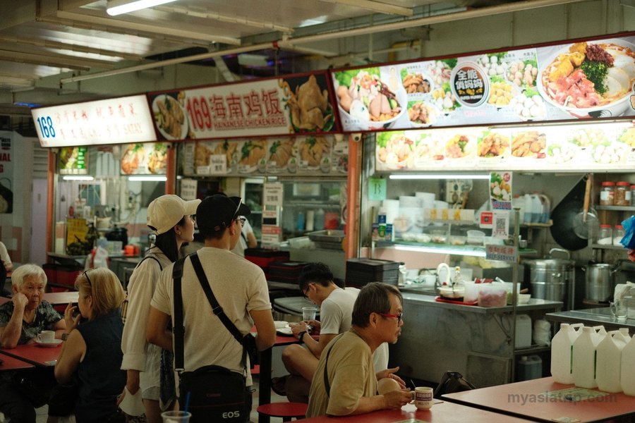 Customers choosing dishes from stalls at a Singapore hawker centre