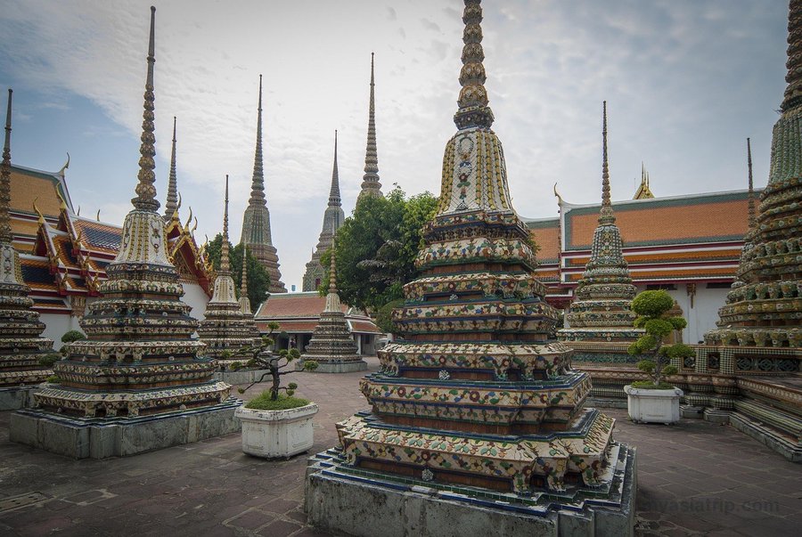 Colorful tiled chedis and temple roofs at Wat Pho in Bangkok