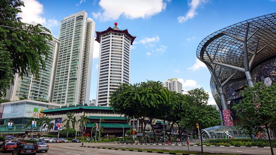 Modern buildings, trees and pedestrian space along Orchard Road in Singapore