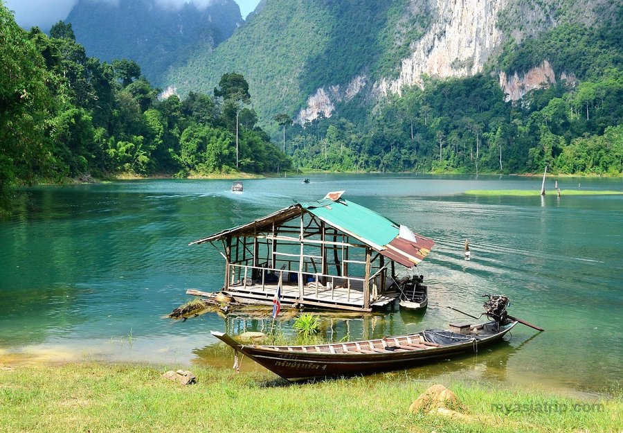 Floating accommodation and boat on a lake in Khao Sok National Park